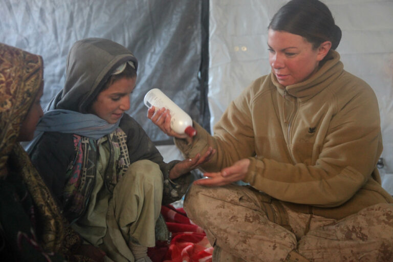 Hospital Corpsman 3rd Class gives basic hygiene class during health initiative in Sangin, Afghanistan